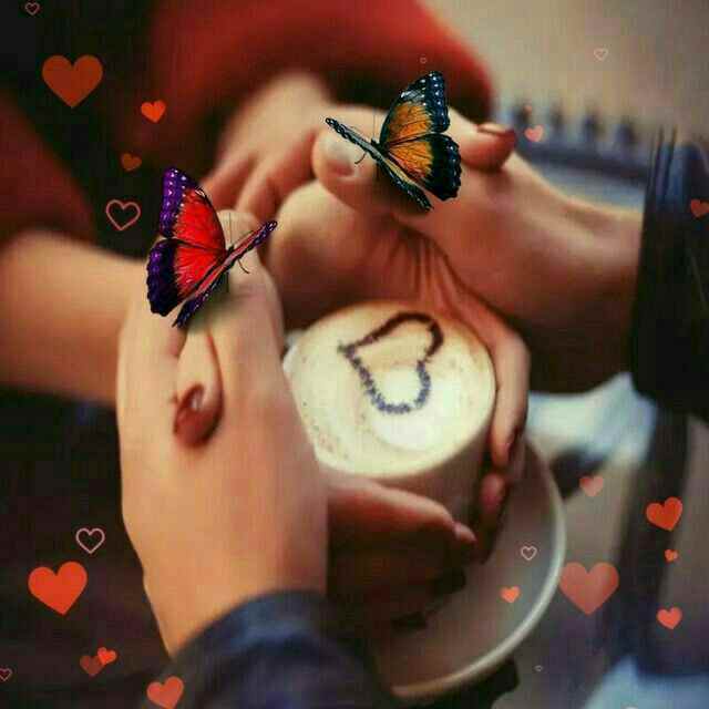 a couple holding hands with butterflies flying around them